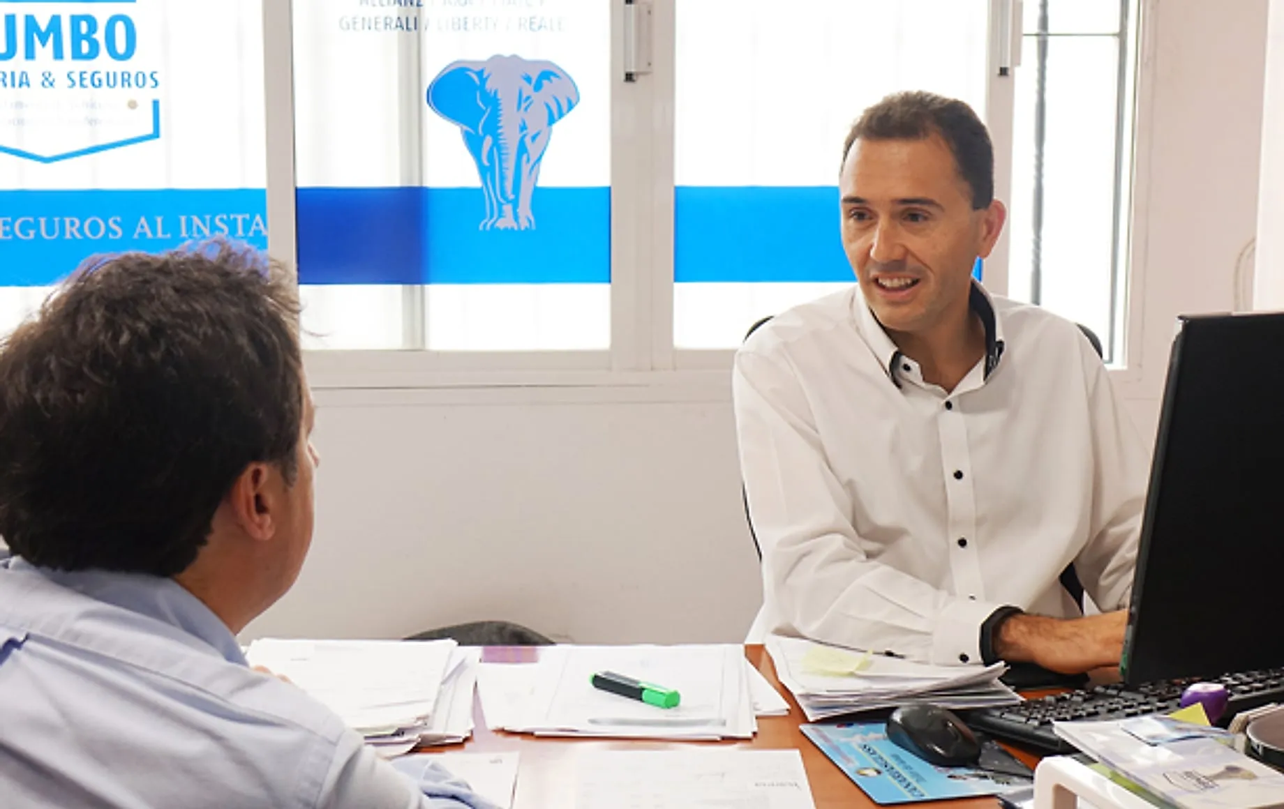 Juan Carlos, director of Rumbo, attending at the office